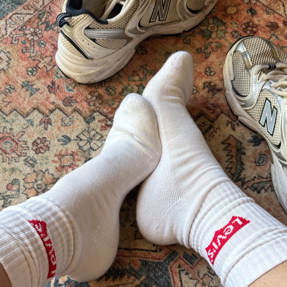 Worn woman’s white Levi’s crew socks
